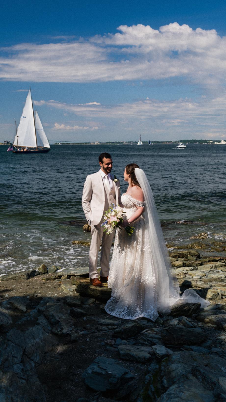 couple kissing in front of sailboat in Newport RI