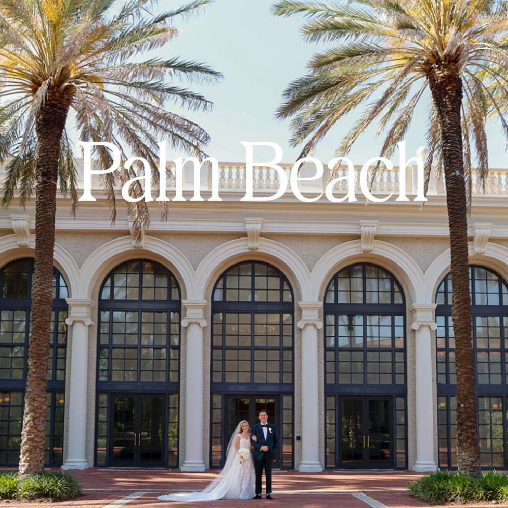 Couple in front of The Breakers Building with palm trees